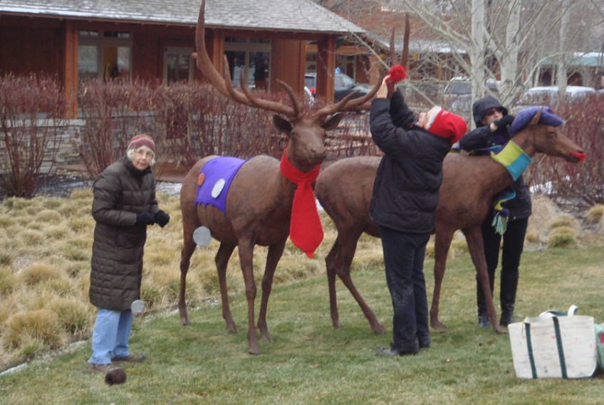 people embellishing steel sculptures